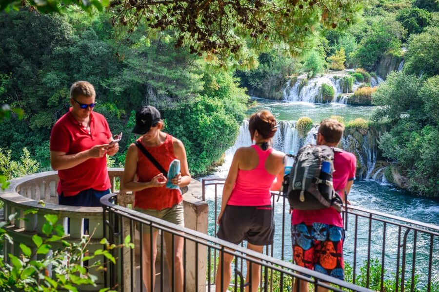 Split/Trogir: Krka National Park Day Trip & Boat to Skradin - Entering Krka National Park: the walk, the waterfalls, and the stone village pieces