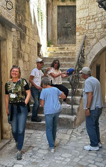 Trogir; Private walking tour of higlights of Trogir - Riva promenade sea views, palm trees, and anchored ships